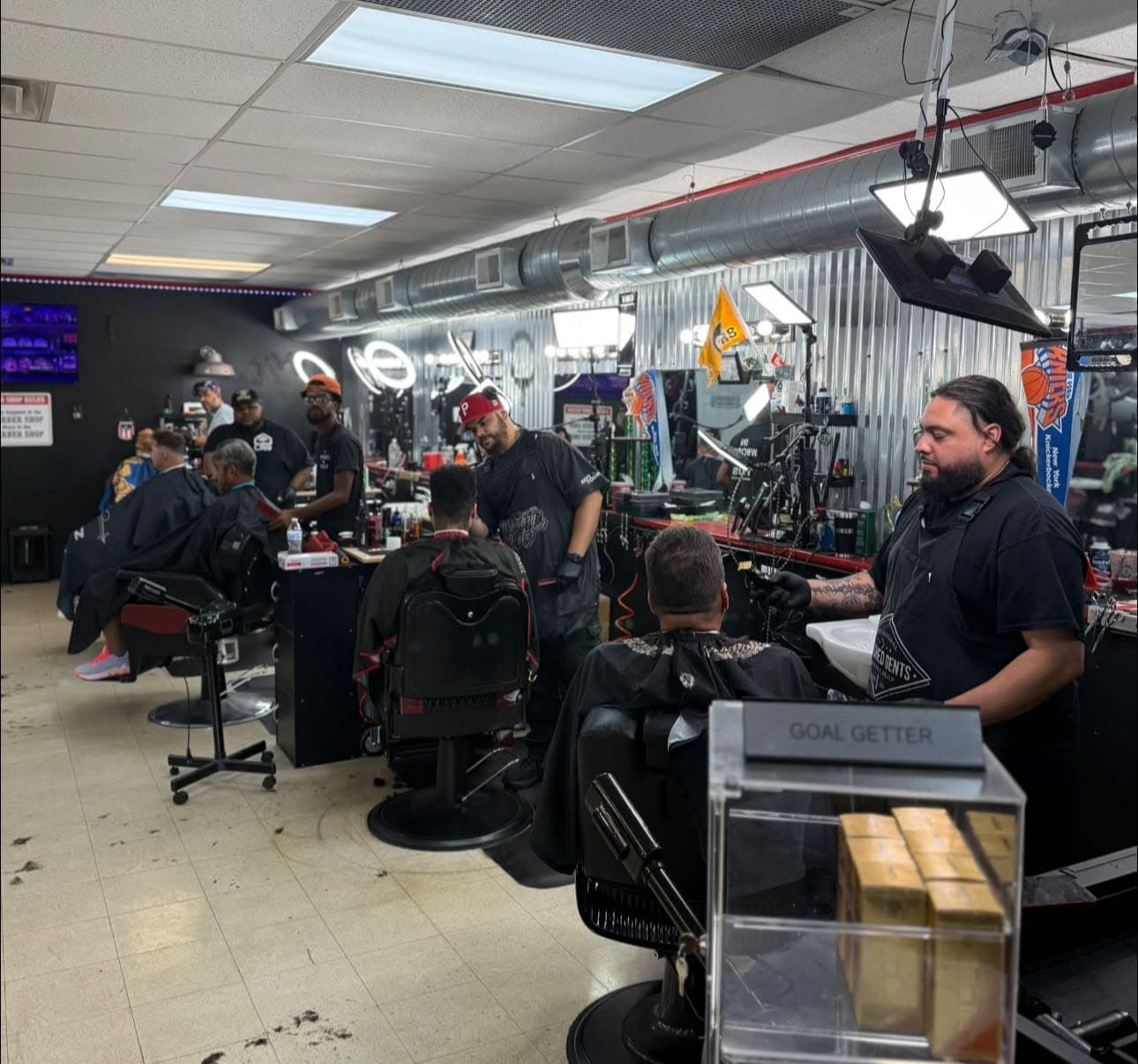 Polished Gents barbers working with clients in the Campbell shop