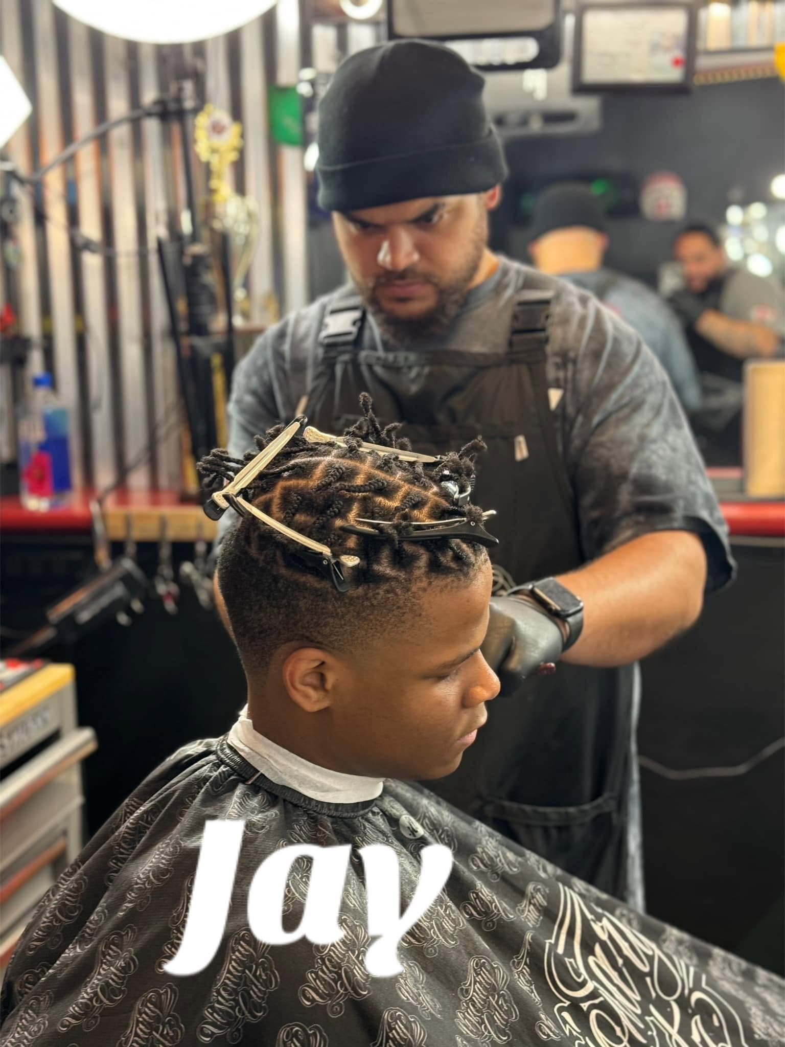 Jason M. cutting client hair
