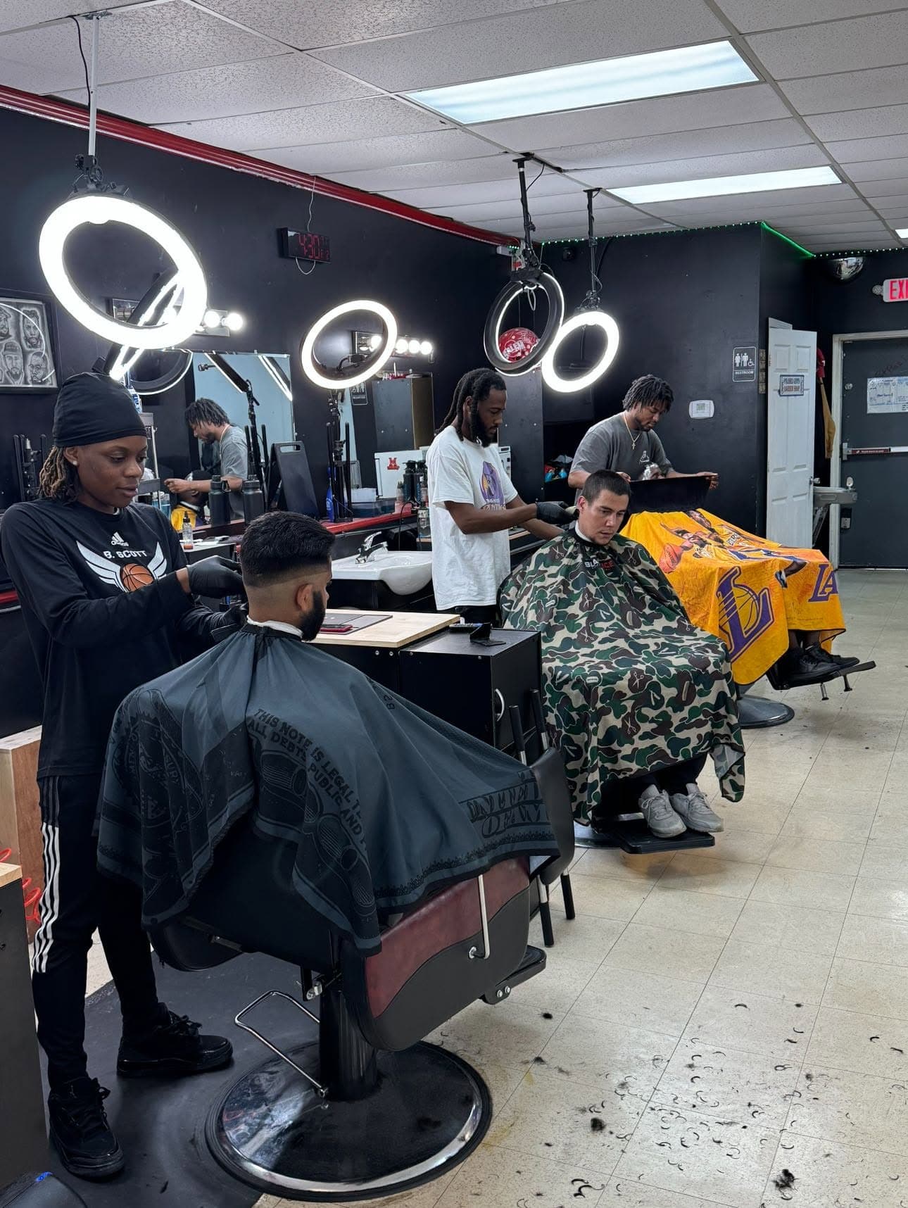 Barbers on the floor during a busy day